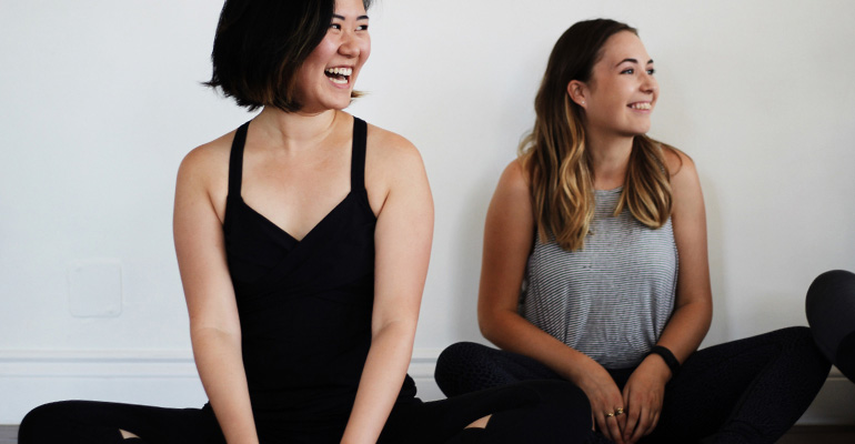 Happy yogis in seated pose