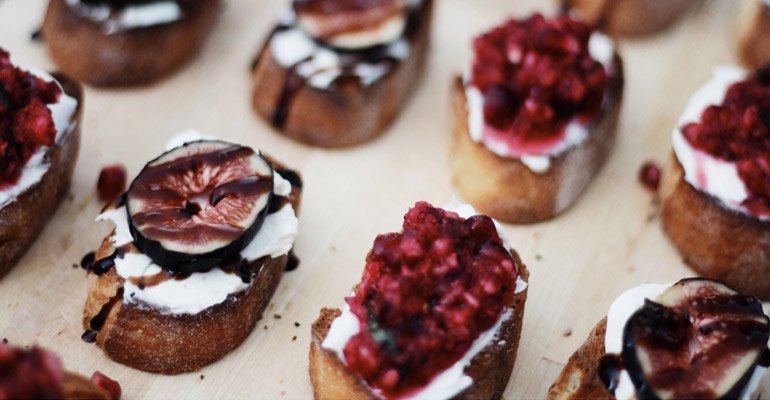 Holiday Crostini with pomegranate and cranberry topping